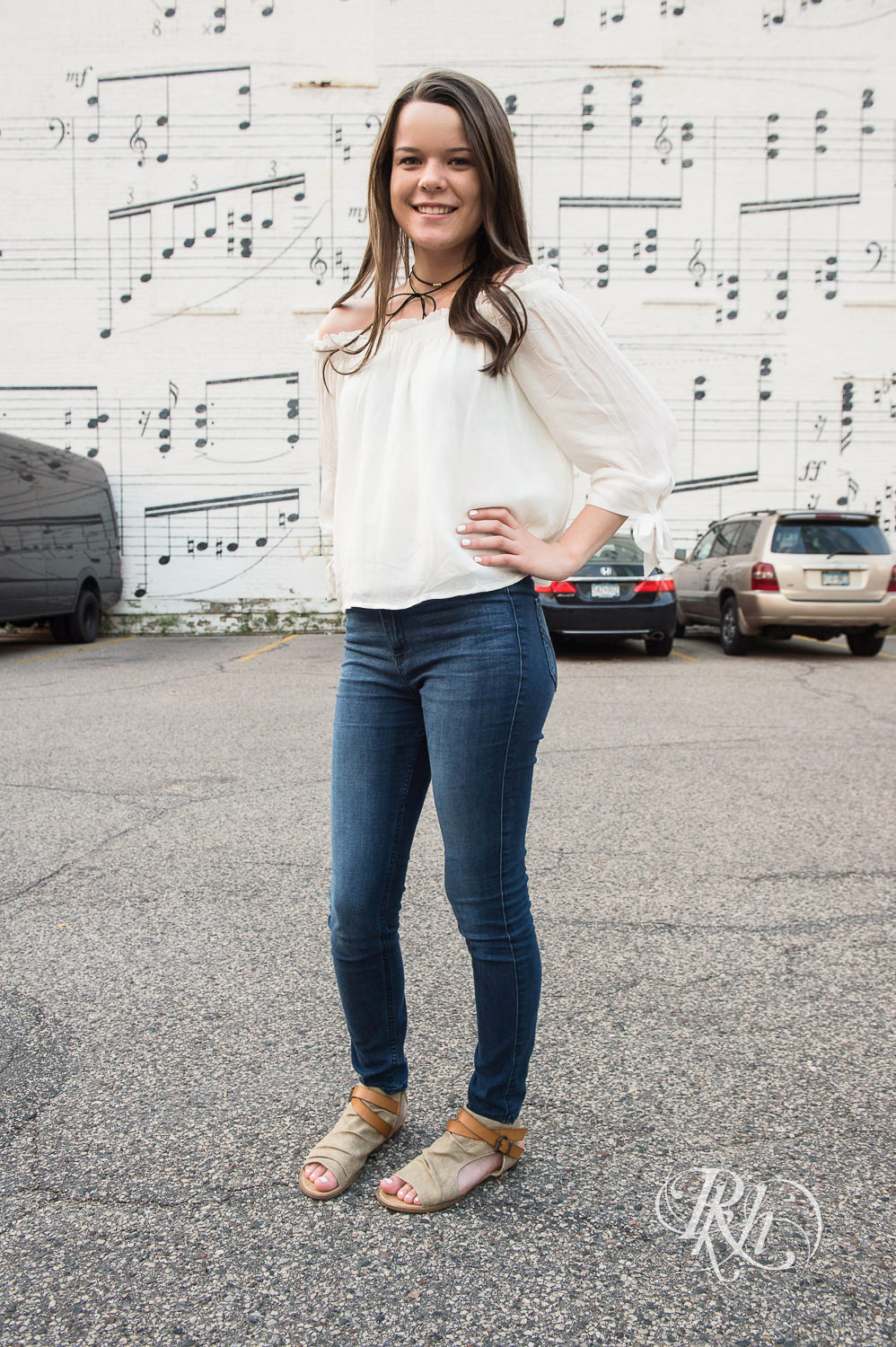 Brunette senior girl standing in front of Schmidt Music in Minneapolis, Minnesota.