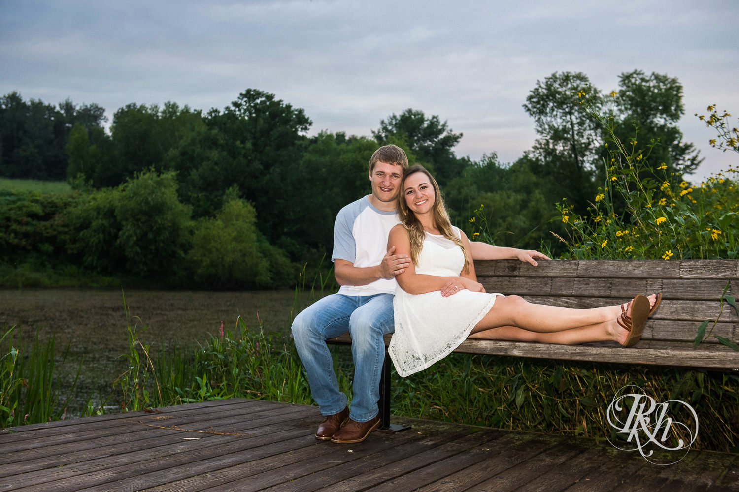 Man and woman smile on a bench at sunrise in Lebanon Hills Regional Park in Eagan, Minnesota.