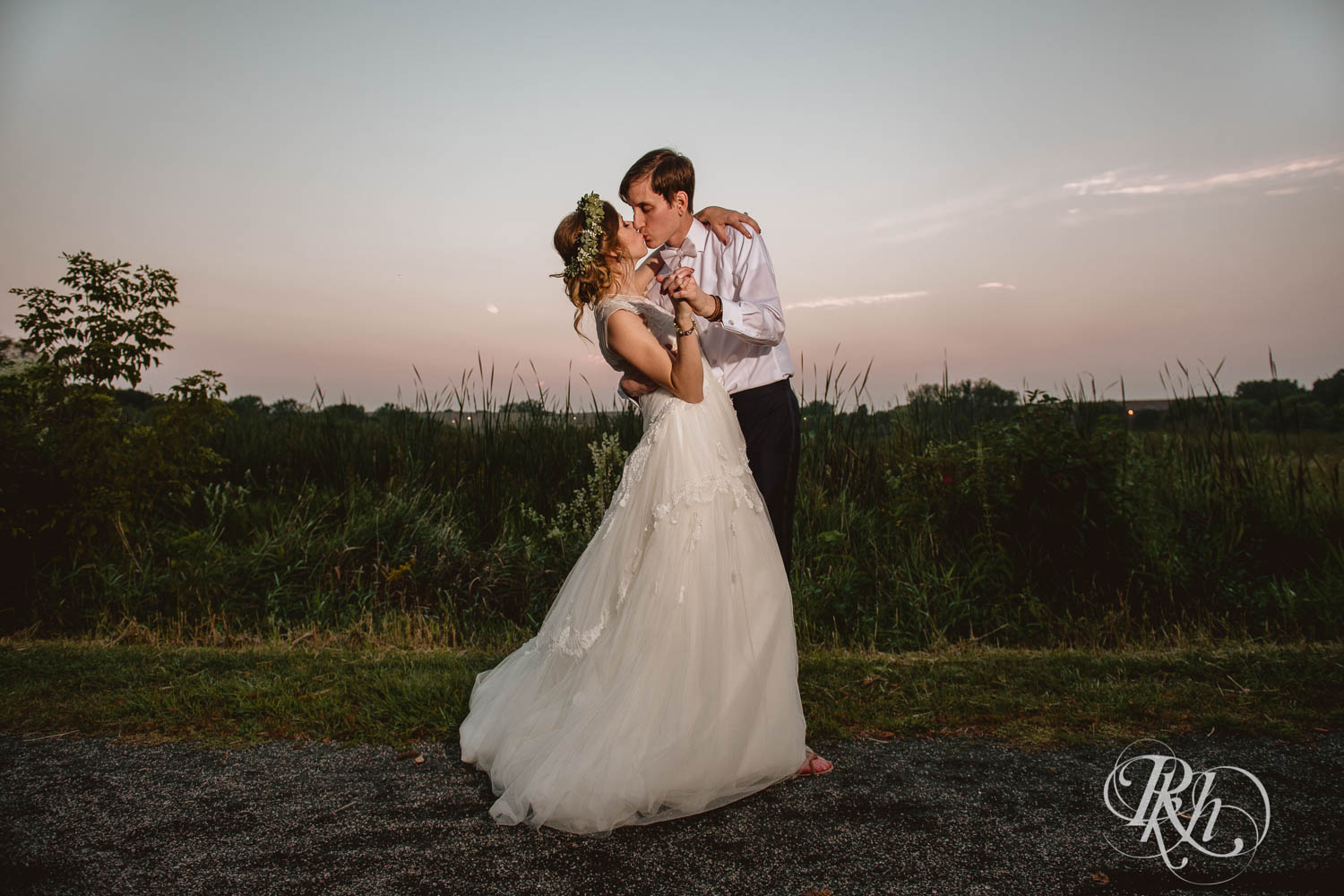 Bride and groom kiss at blue hour during wedding reception at Plymouth Creek Center in Plymouth, Minnesota.