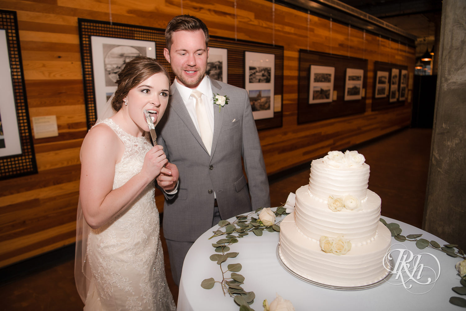 Bride and groom cut cake during wedding reception at Mill City Museum in Minneapolis, Minnesota.