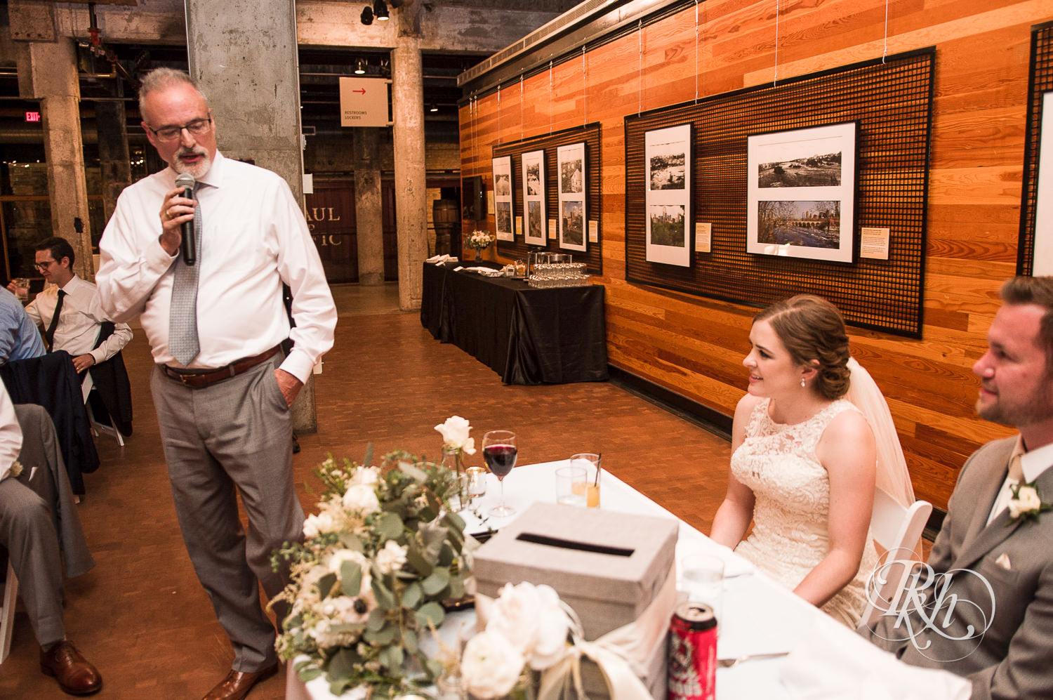 Bride and groom smile during wedding reception at Mill City Museum in Minneapolis, Minnesota.