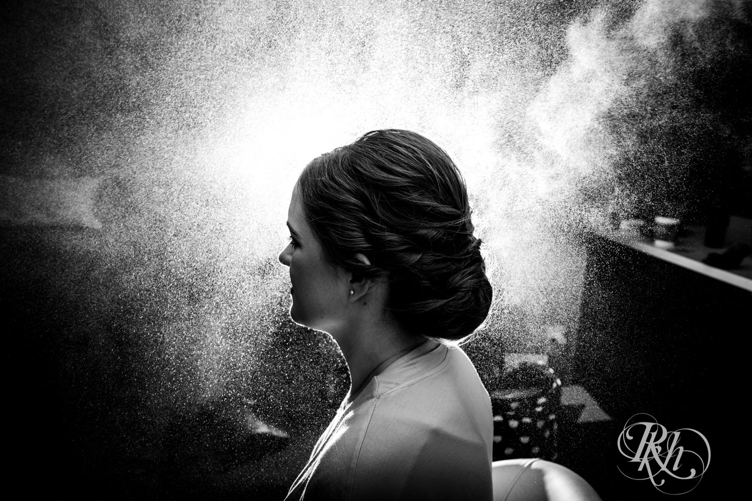 Bride getting hair sprayed before wedding in Renaissance Hotel in Minneapolis, Minnesota. 
