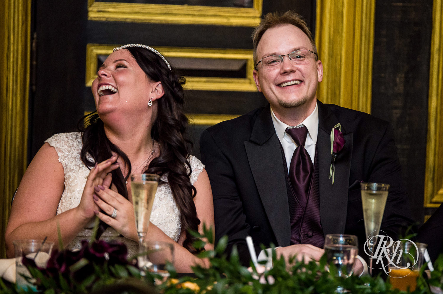 Bride and groom laugh during indoor wedding reception at Kellerman's Event Center in White Bear Lake, Minnesota.