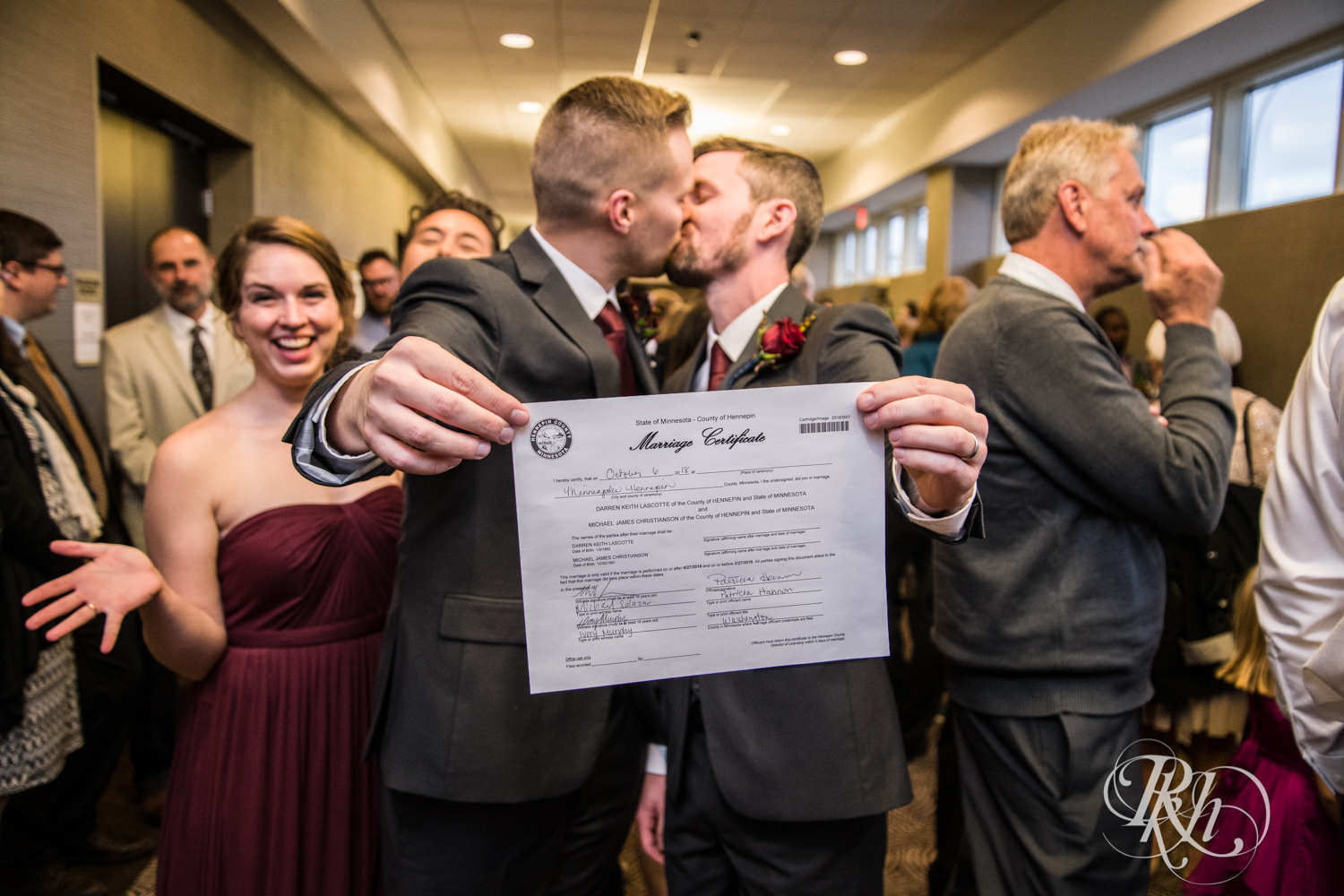 Grooms kiss after LGBTQ wedding ceremony at Courtyard by Marriott Minneapolis.