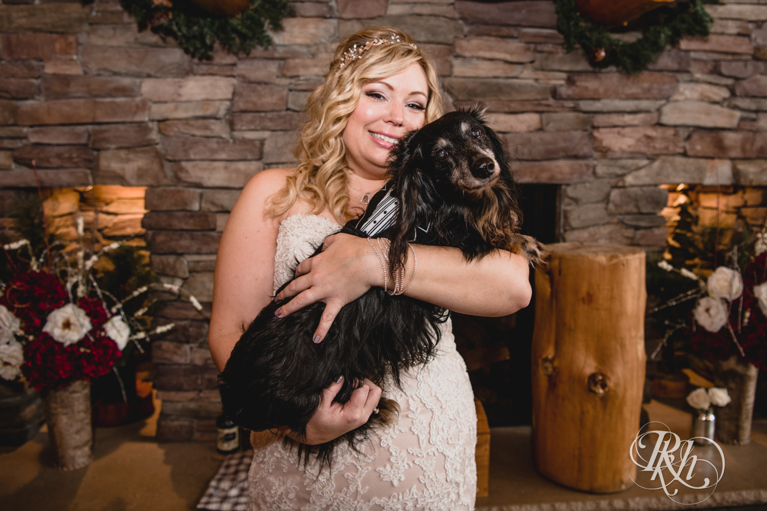 Bride holds dog at Whitefish Lodge in Crosslake, Minnesota.