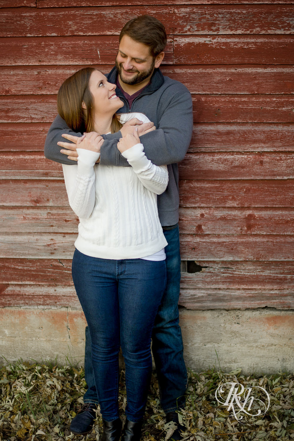 Man and woman smiling during engagement photography session at home in Annandale, Minnesota.