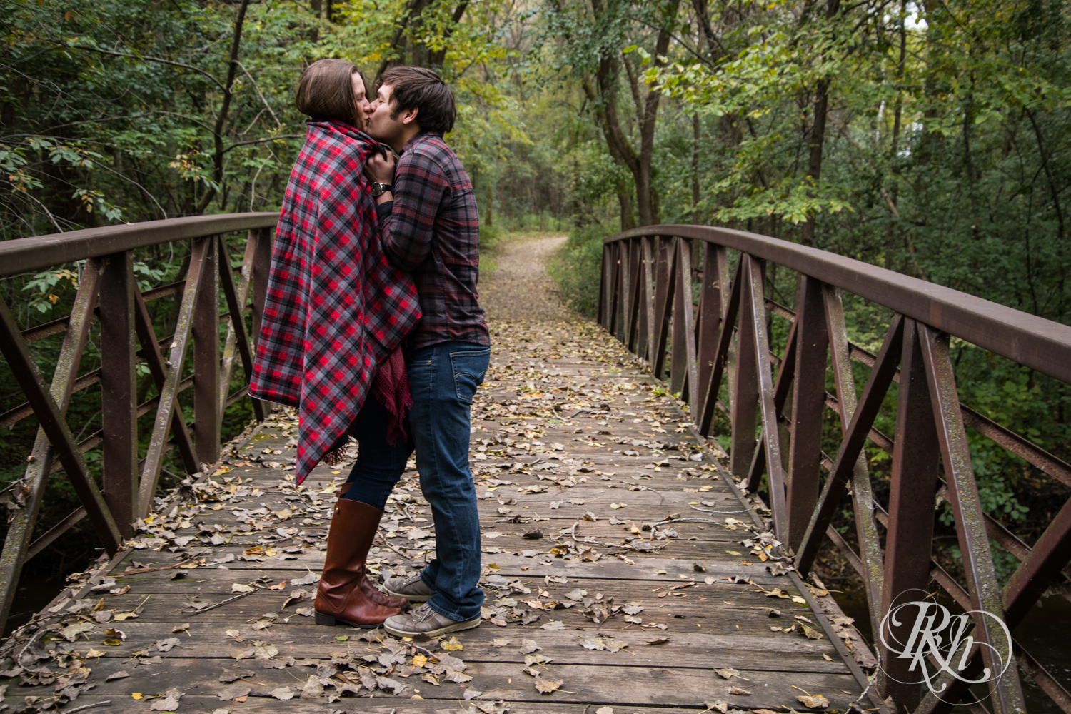 Man and woman kiss on bridge in Minneapolis, Minnesota.
