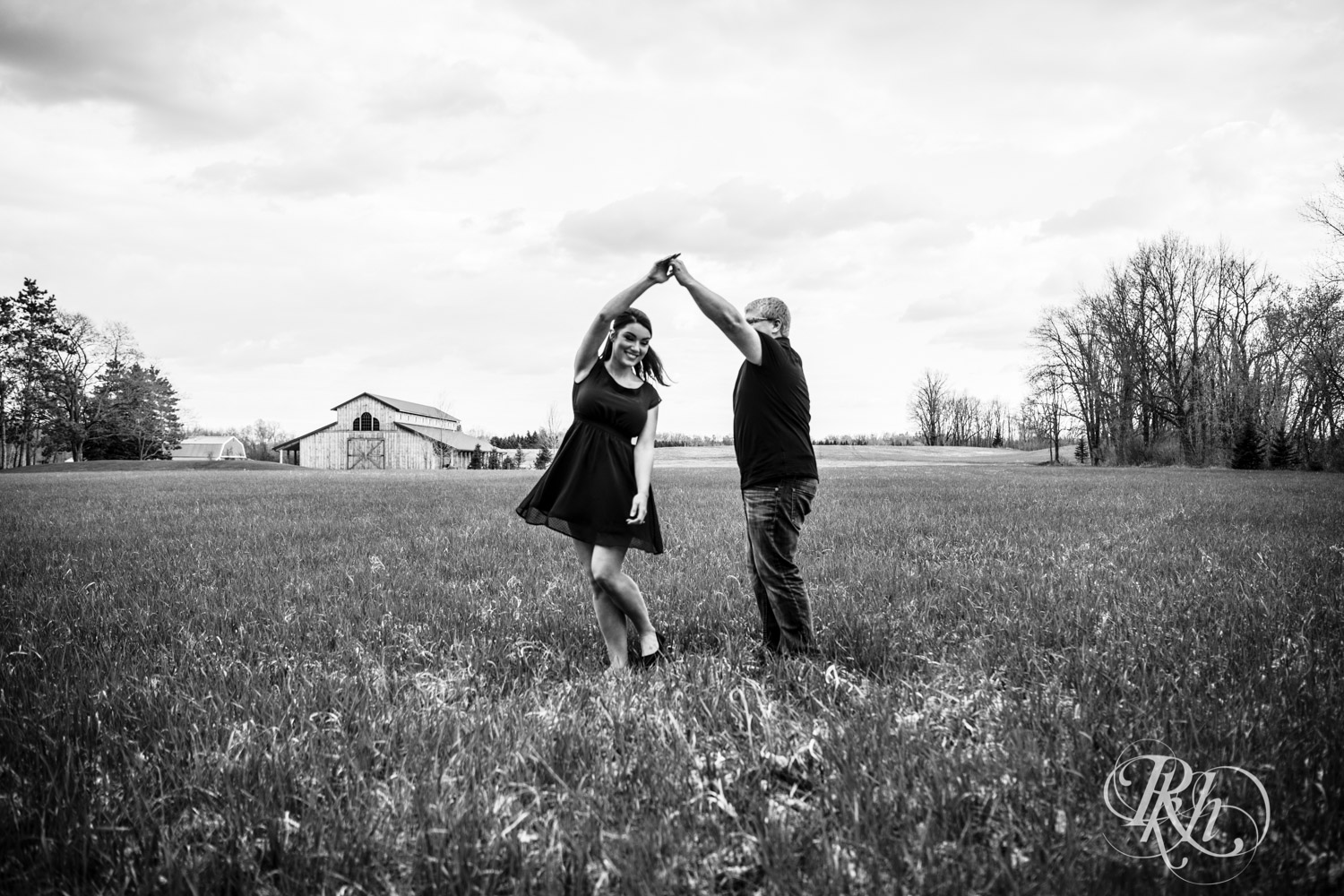 Man and woman dance in field at Creekside Farm and Events in Rush City, Minnesota.