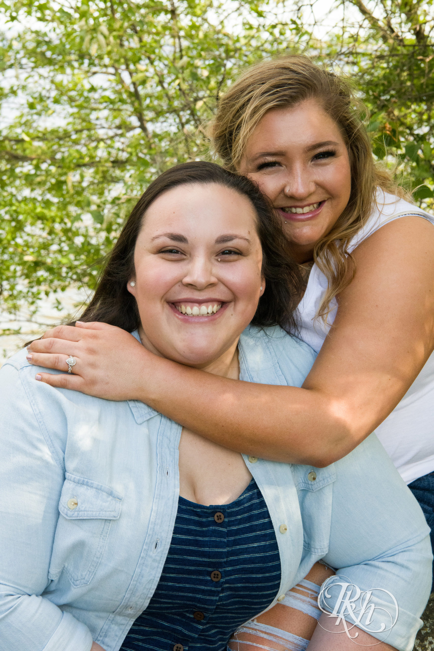 Lesbian couple smiles during engagement session in Duluth, Minnesota.