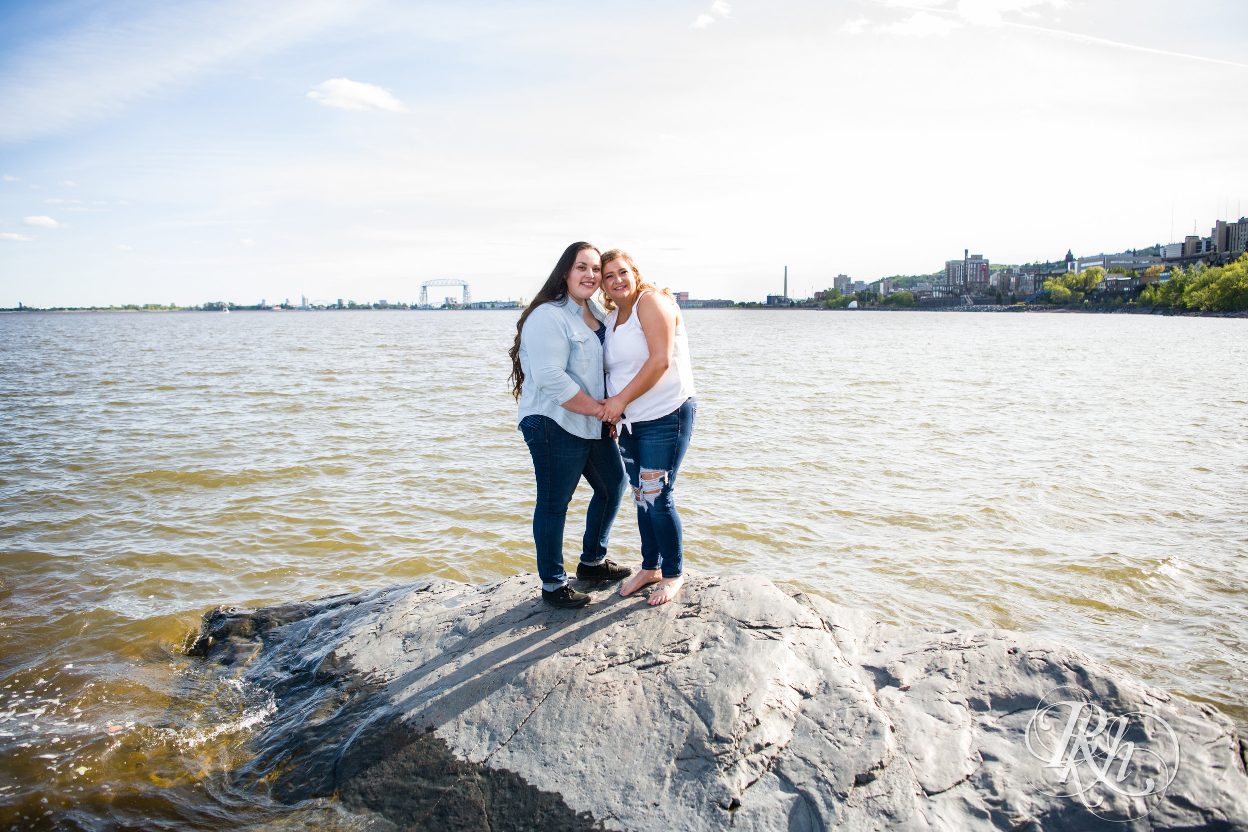 Lesbian couple smiles during engagement session in Duluth, Minnesota.