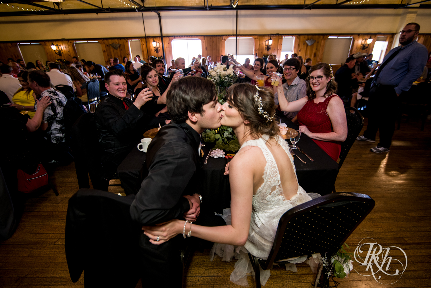 Bride and groom kiss at wedding reception at Kellerman's Event Center in White Bear Lake, Minnesota.