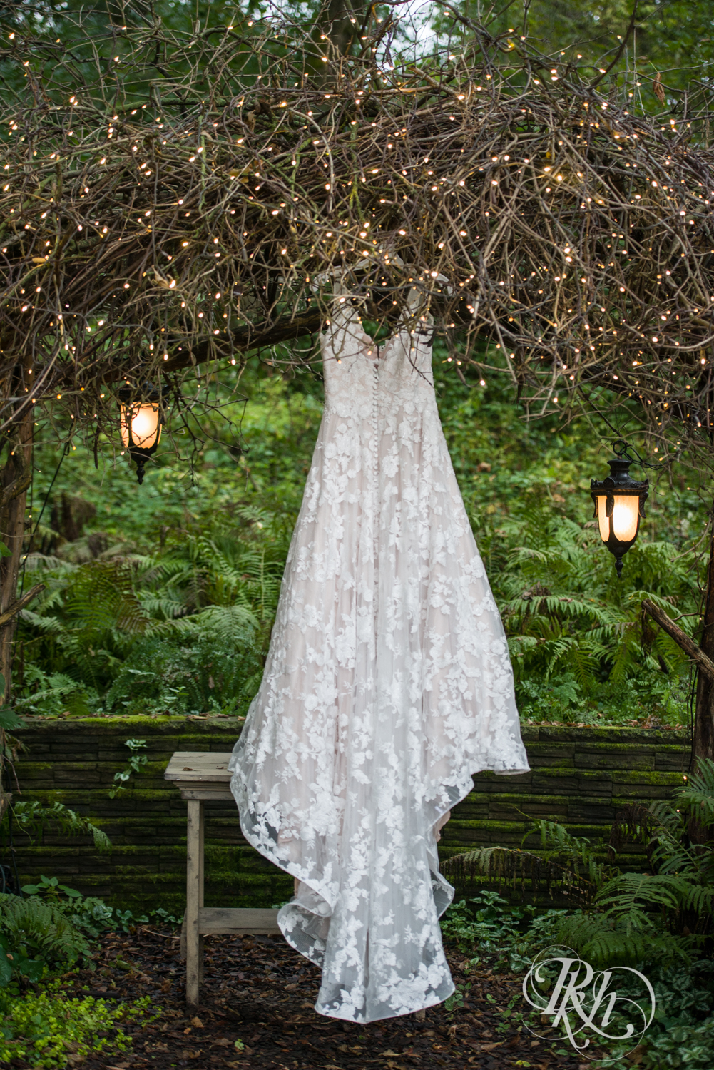 Wedding dress hanging in arbor at Camrose Hill Flower Farm in Stillwater, Minnesota.