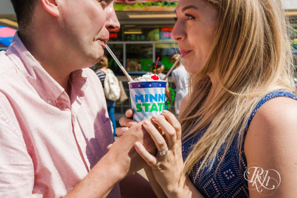 Man and woman in blue dress sharing a sundae at the Minnesota State Fair.