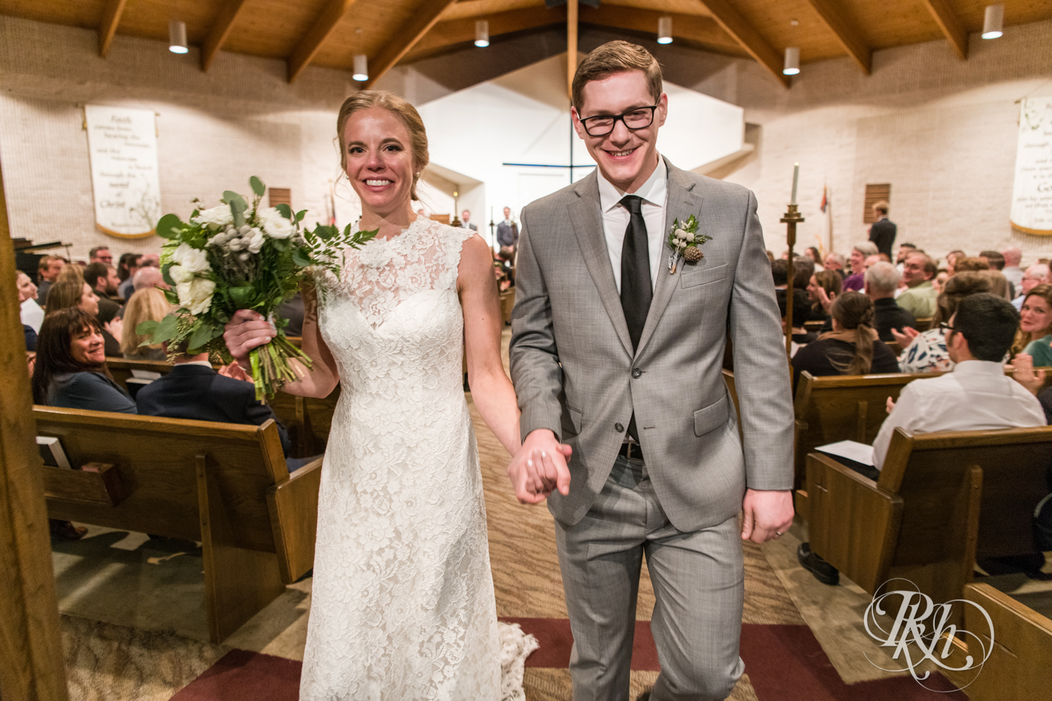 Bride and groom walk down aisle after church wedding ceremony in Golden Valley, Minnesota.