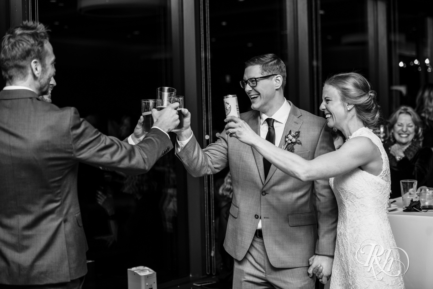 Bride and groom toast at wedding reception at Brookview Golf Course in Golden Valley, Minnesota.
