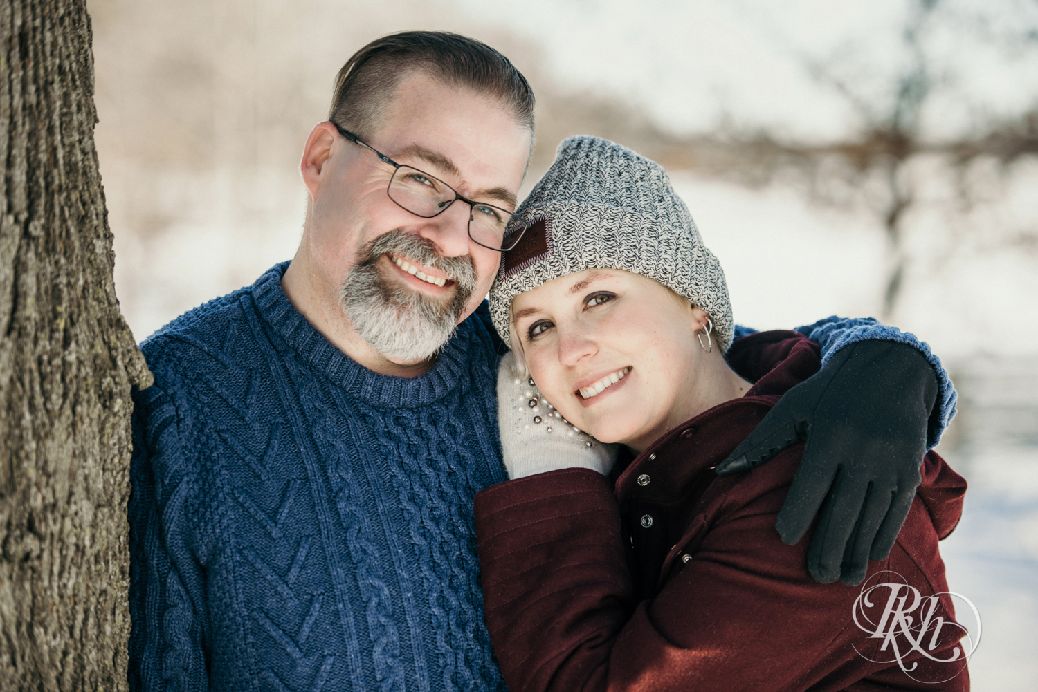 Man and woman smile in the snow in Cleary Lake in Prior Lake, Minnesota.