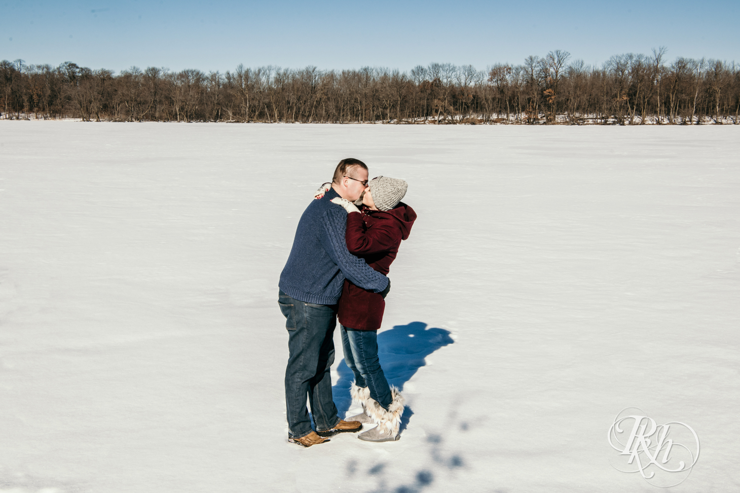 couple kissing on ice covered Cleary Lake