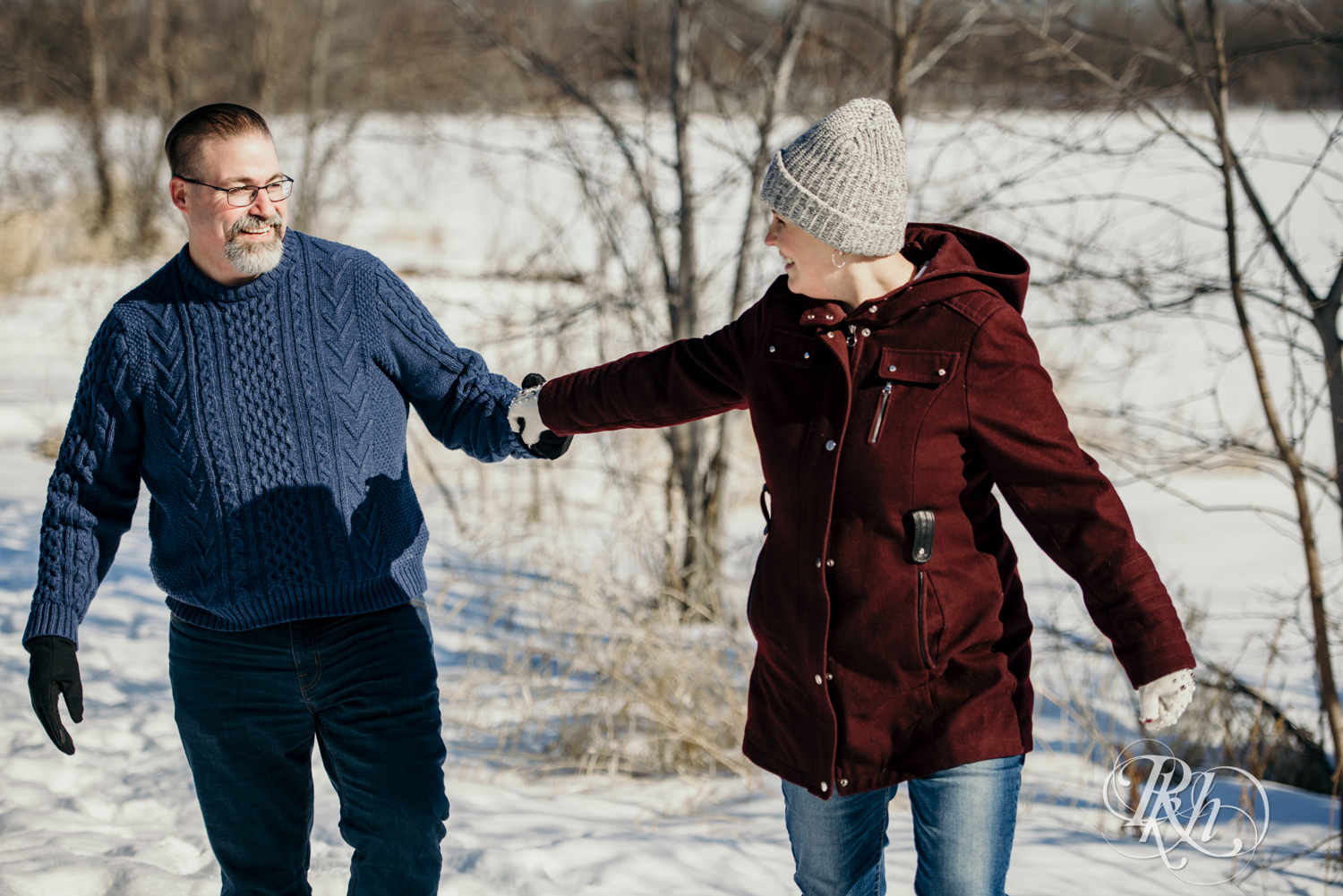 Man and woman laugh in the snow in Cleary Lake in Prior Lake, Minnesota.