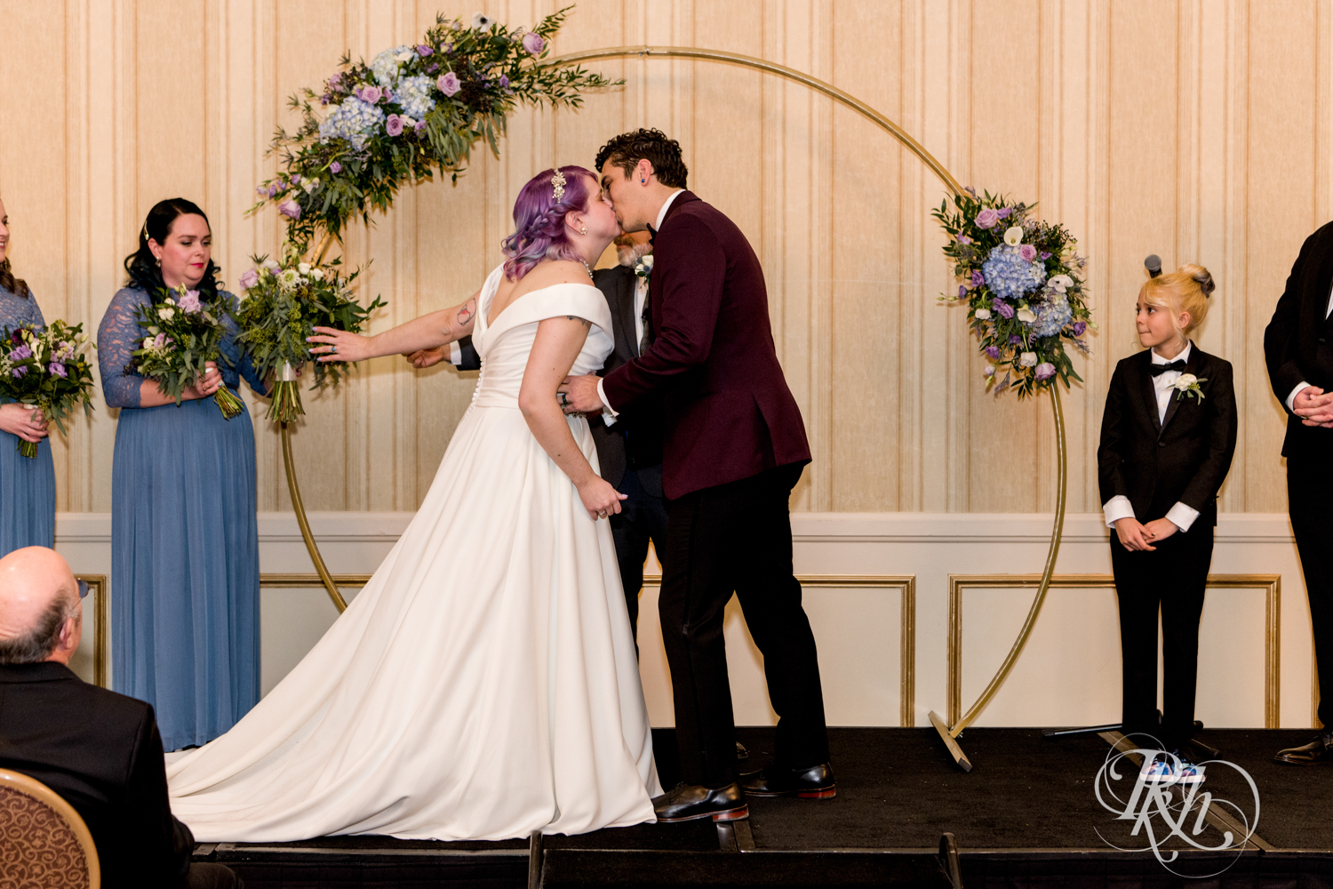 Bride and groom kiss at wedding ceremony at the Saint Paul Hotel in Saint Paul, Minnesota.