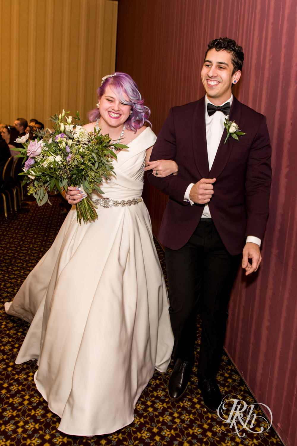 Bride and groom smiling at wedding ceremony at the Saint Paul Hotel in Saint Paul, Minnesota.