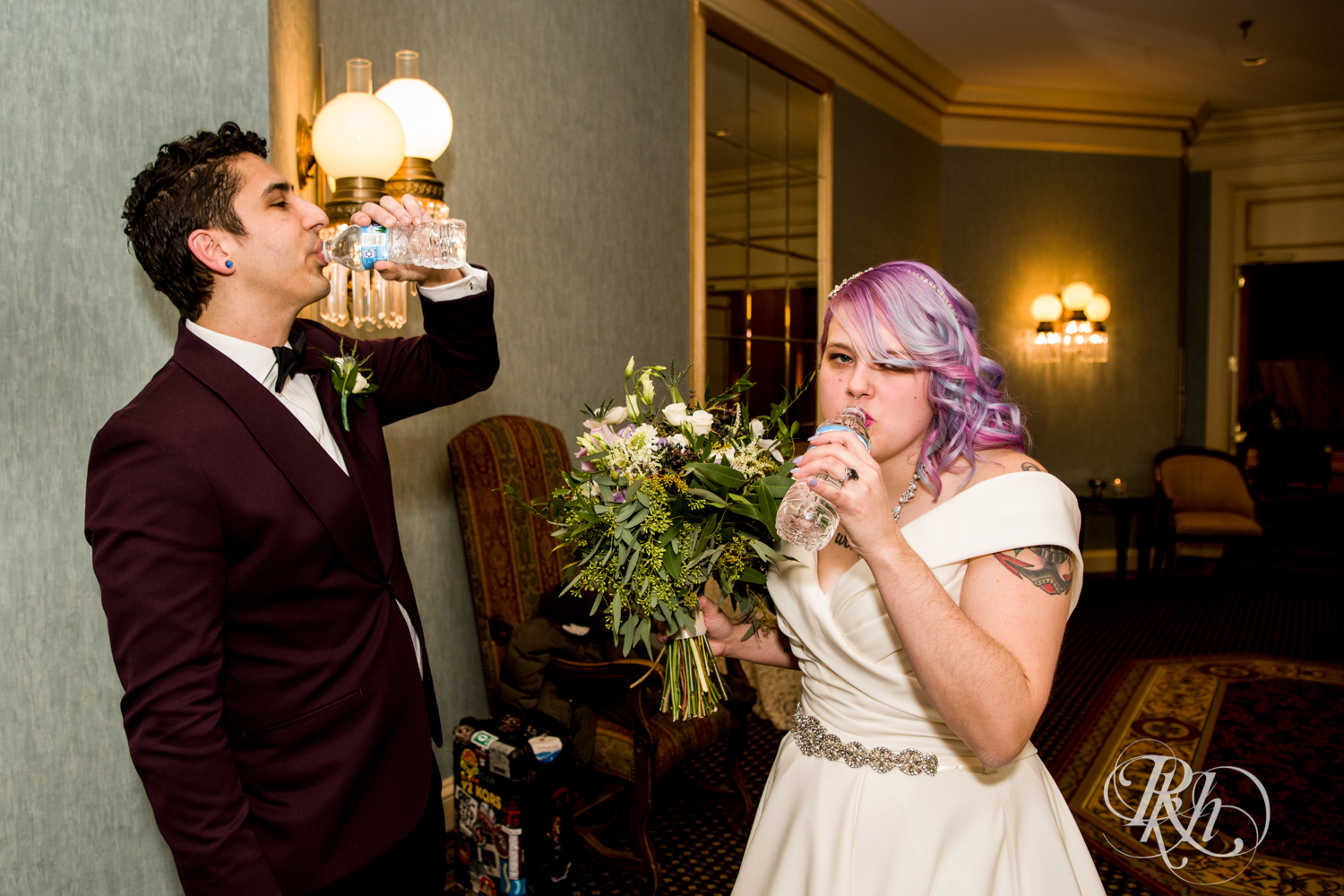 Bride and groom drinking water after wedding ceremony at the Saint Paul Hotel in Saint Paul, Minnesota.