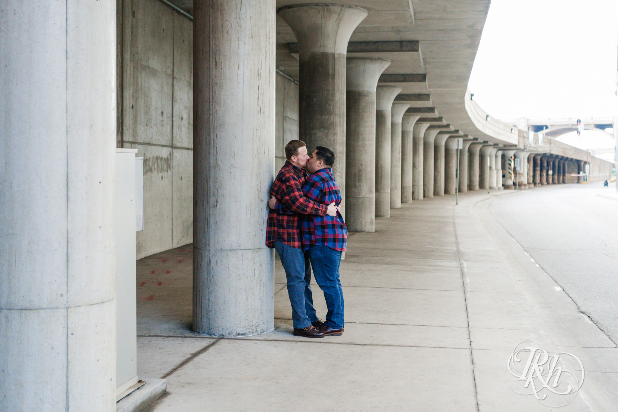 Two gay men in flannels kiss near Union Depot in Saint Paul, Minnesota.