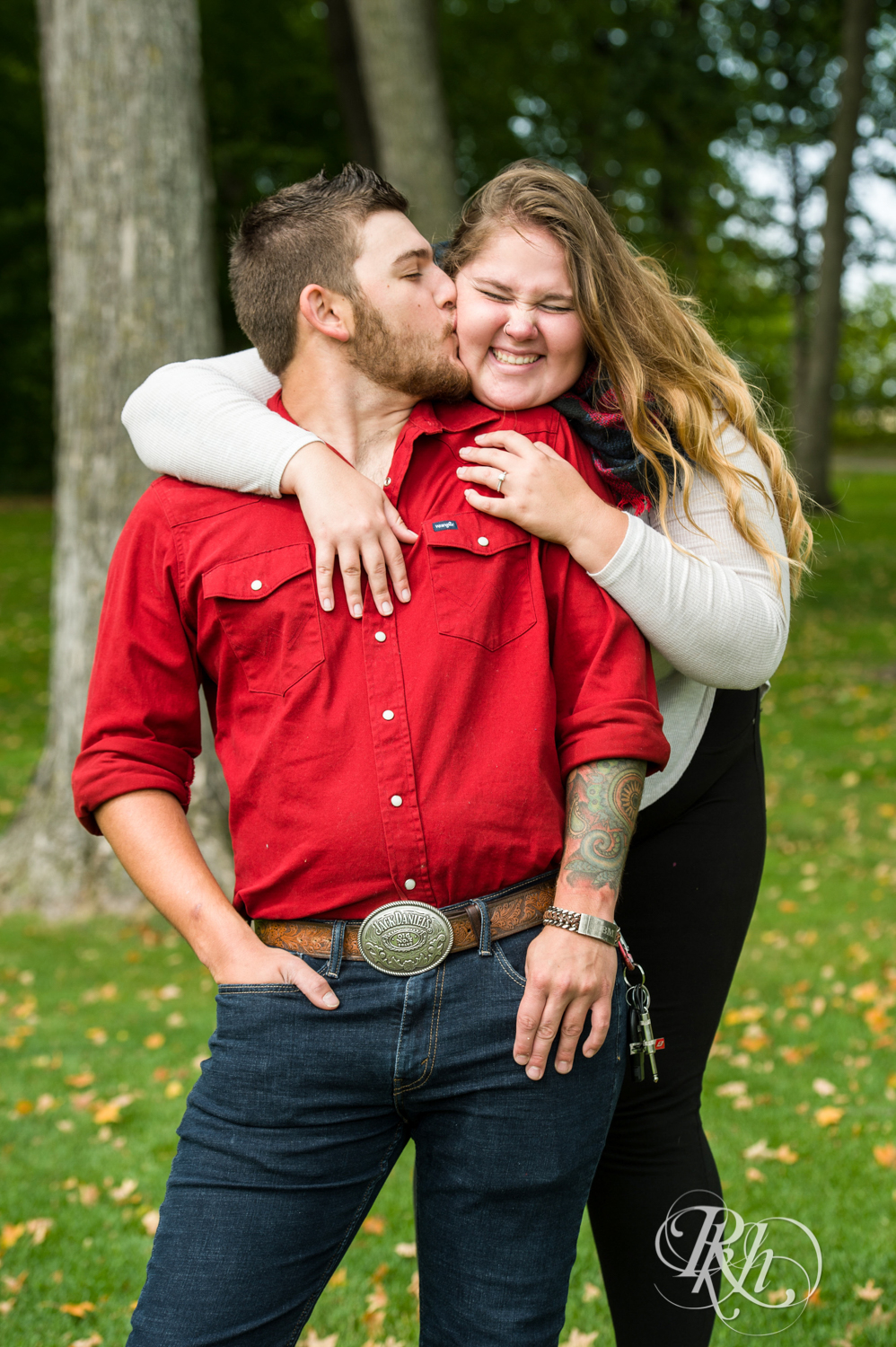 Man and woman in jeans and dress shirts kiss at Hilde Performance Center in Plymouth, Minnesota.