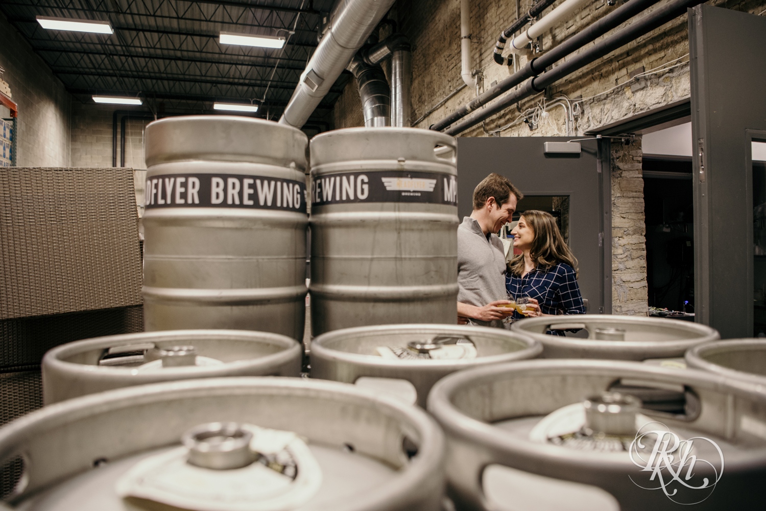 couple standing by beer kegs