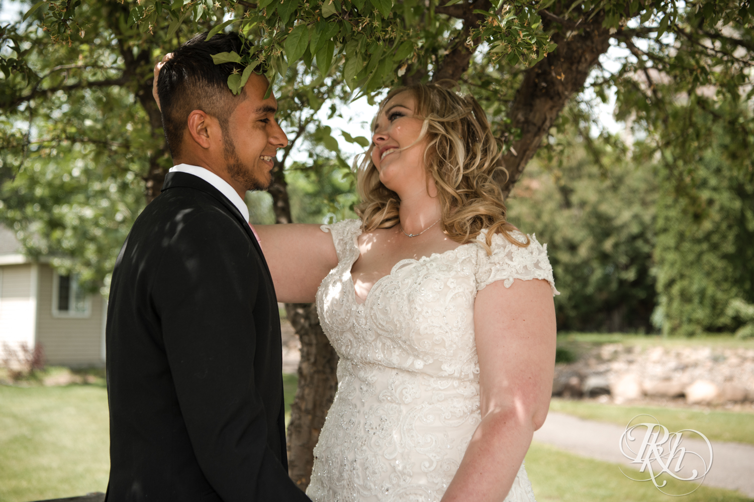 Bride and groom share first look at Izatys Resort in Onamia, Minnesota on a summer day.