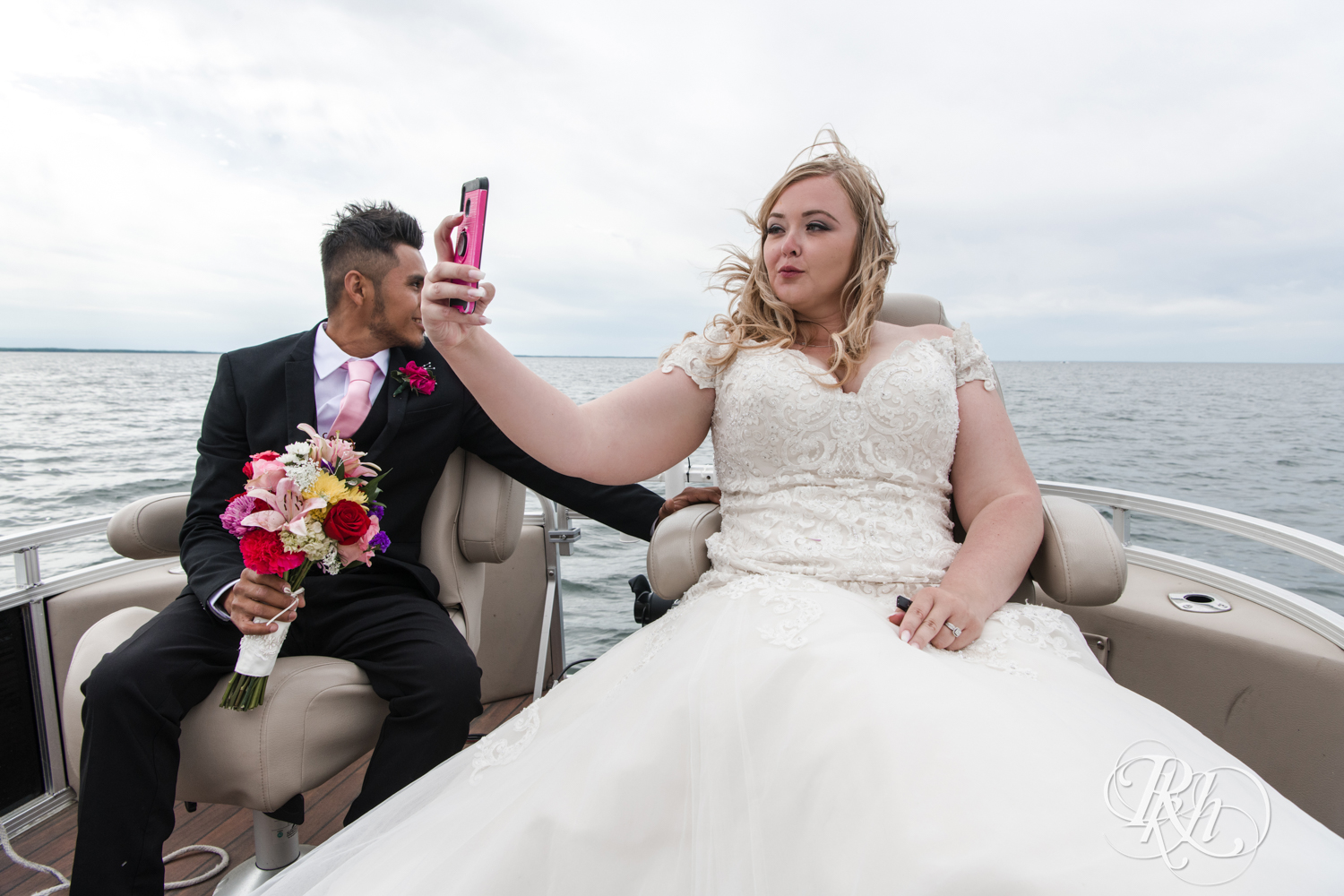 Bride takes self on boat on Lake Mille Lacs at Izatys Resort in Onamia, Minnesota.