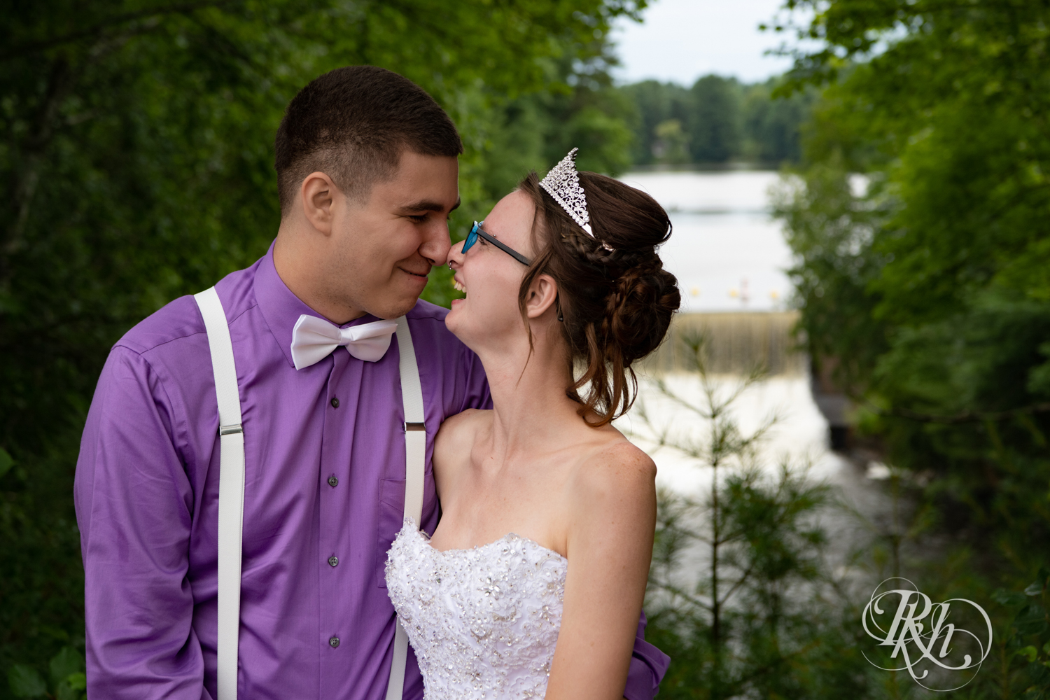 Bride and groom laugh in the rain in Irvine Park in Chippewa Falls, Wisconsin. 