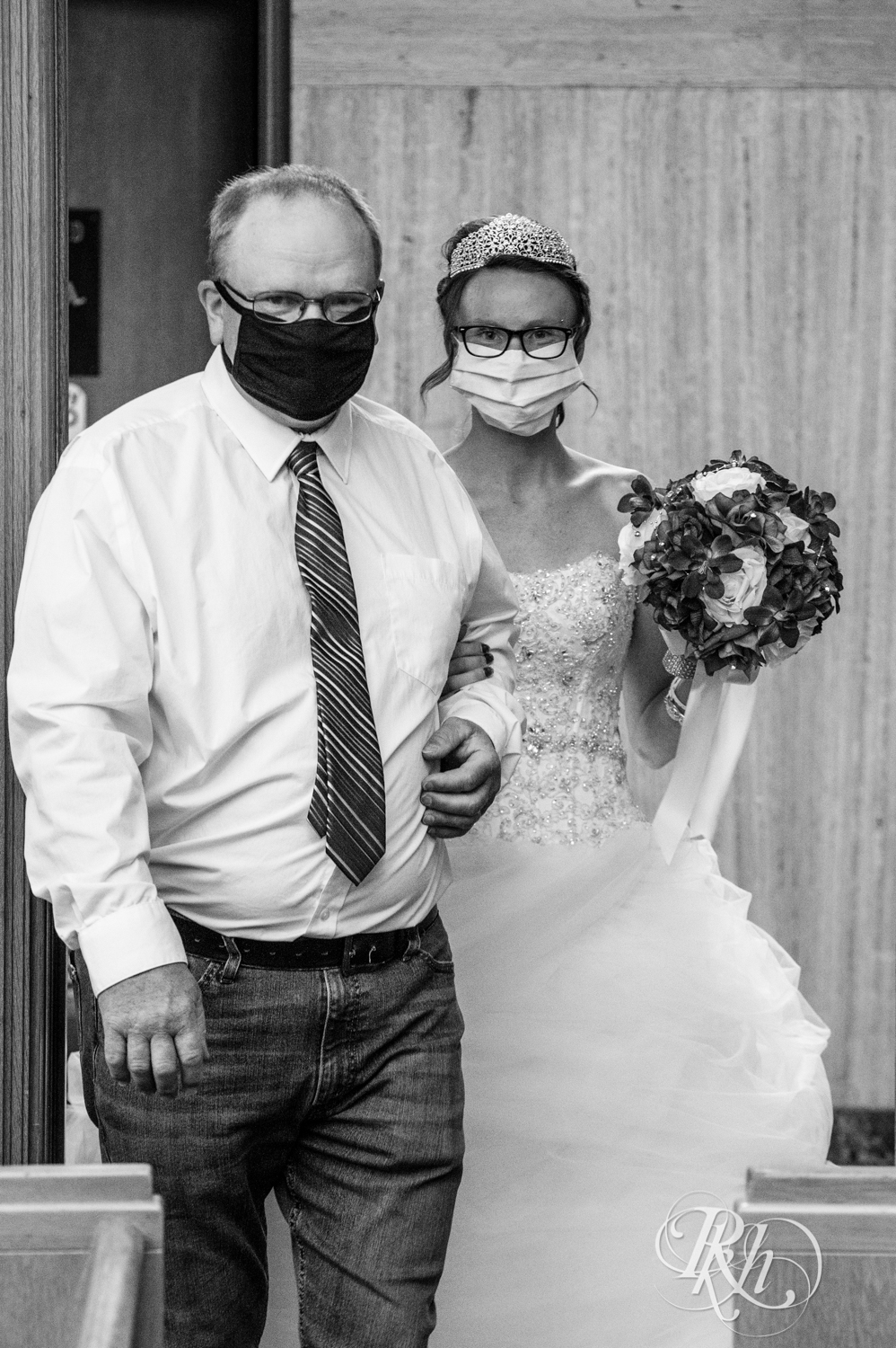 father walking bride with masks