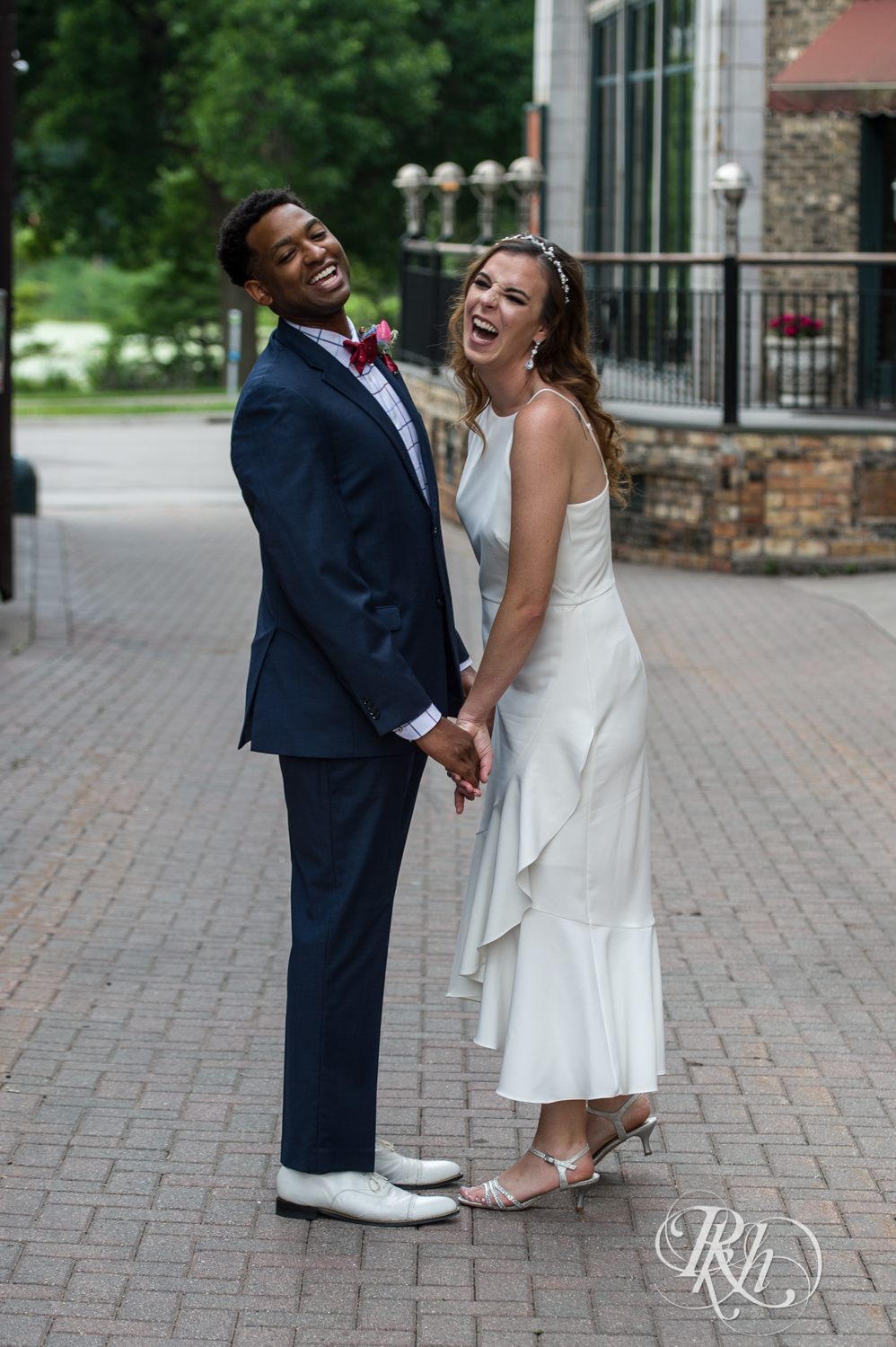 Black man and woman biracial couple laugh in Loring Park in Minneapolis, Minnesota.