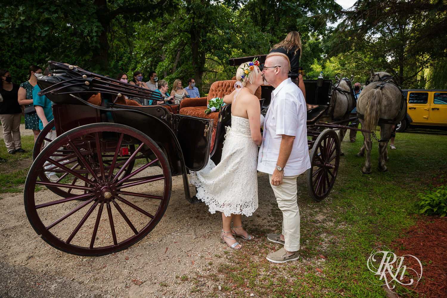 Bride and groom enter reception in horse drawn carriage in Prior Lake, Minnesota. 