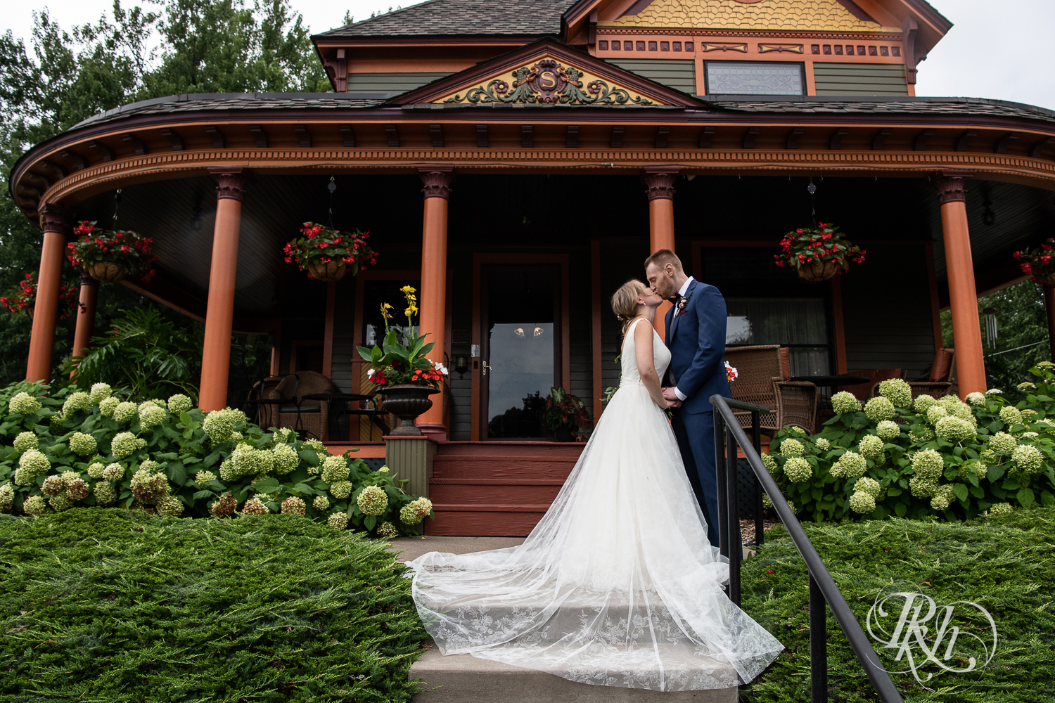 Bride and groom smile at the William Sauntry Mansion in Stillwater, Minnesota.