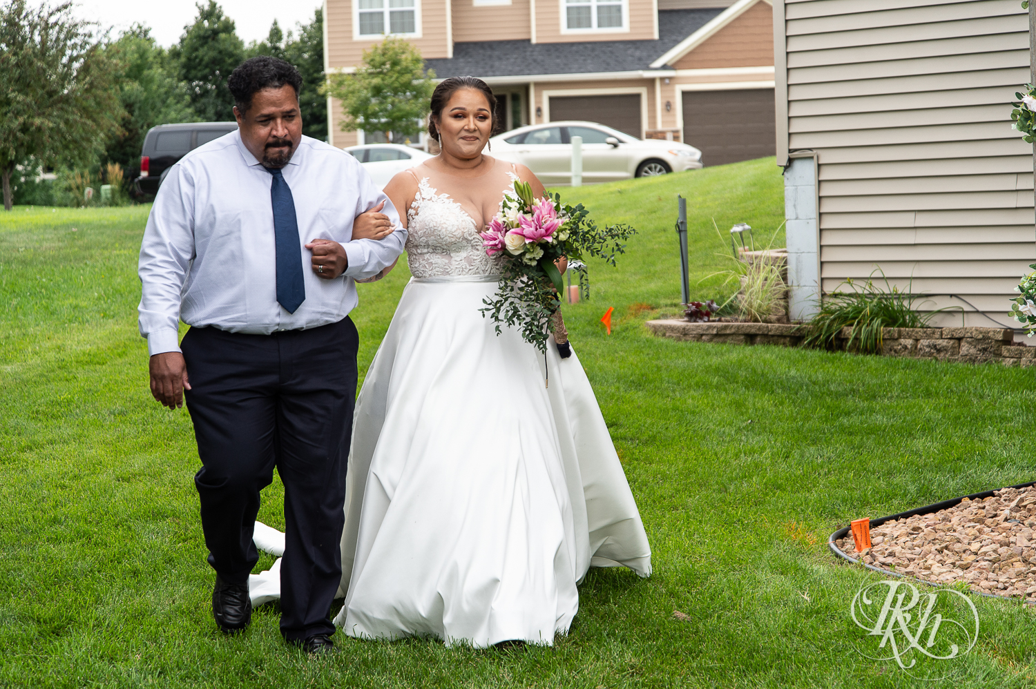 Black bride walks down the aisle with dad at home wedding in Brooklyn Park, Minnesota.