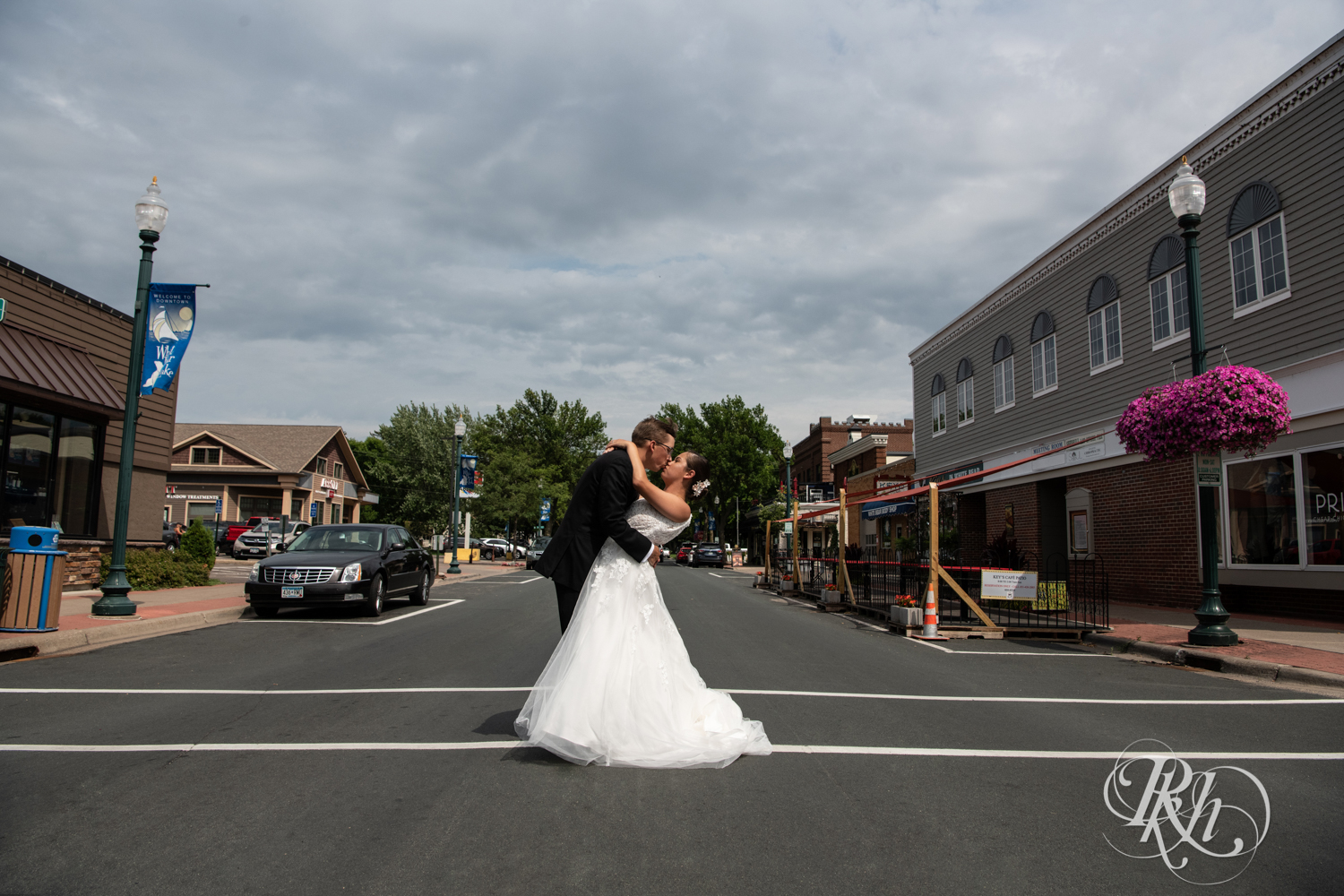 bride and groom kissing in middle of road
