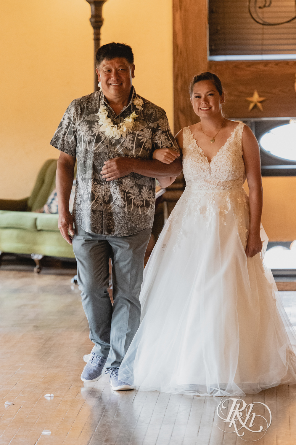 Bride walks down the aisle with her dad in a Hawaiian shirt at Kellerman's Event Center in White Bear Lake, Minnesota.
