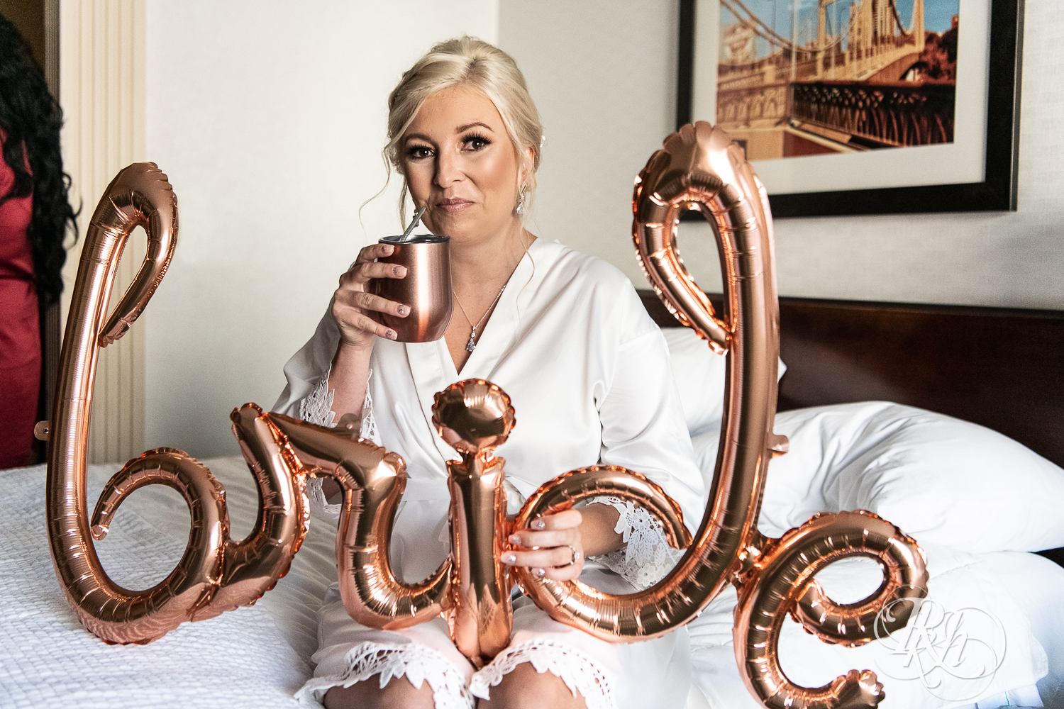 Bride holding bride balloon and drinking Moscow Mule