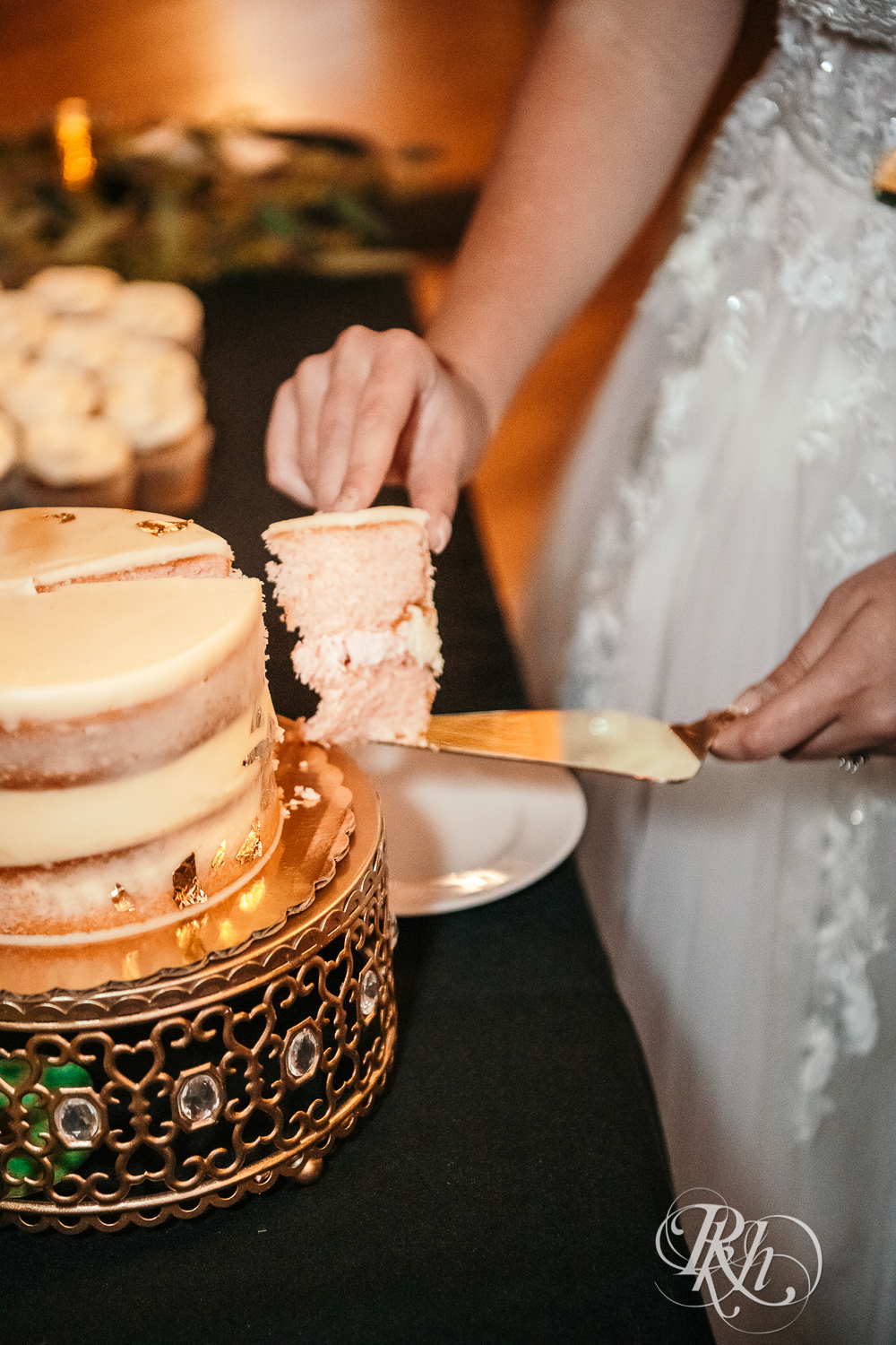 Bride and groom cut wedding cake at Green Acres Event Center in Eden Prairie, Minnesota.
