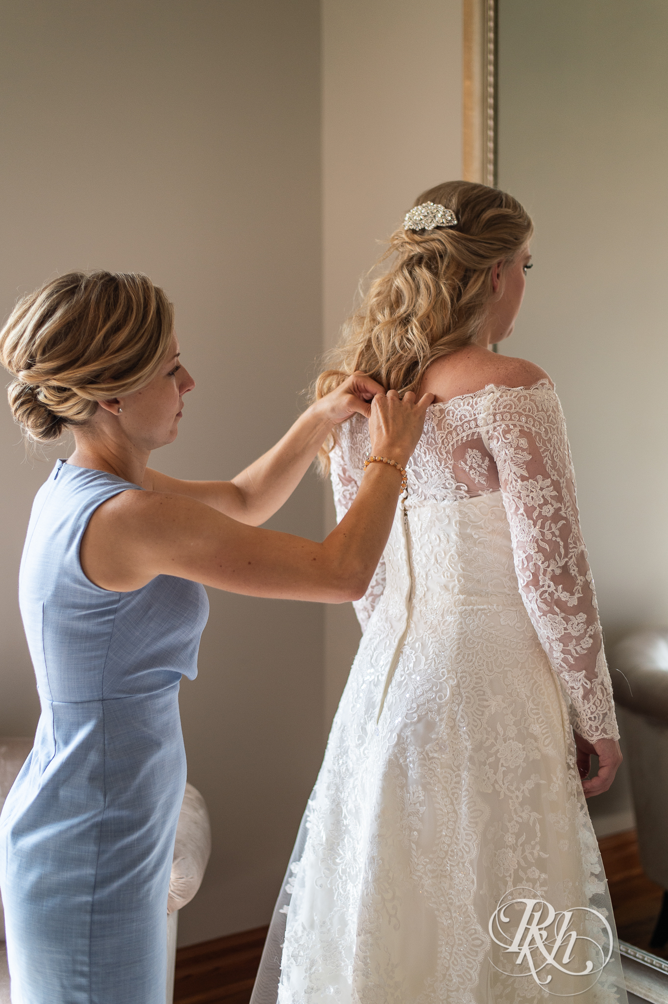 Bride getting dress put on before wedding at Weddings at the Broz in New Prague, Minnesota.