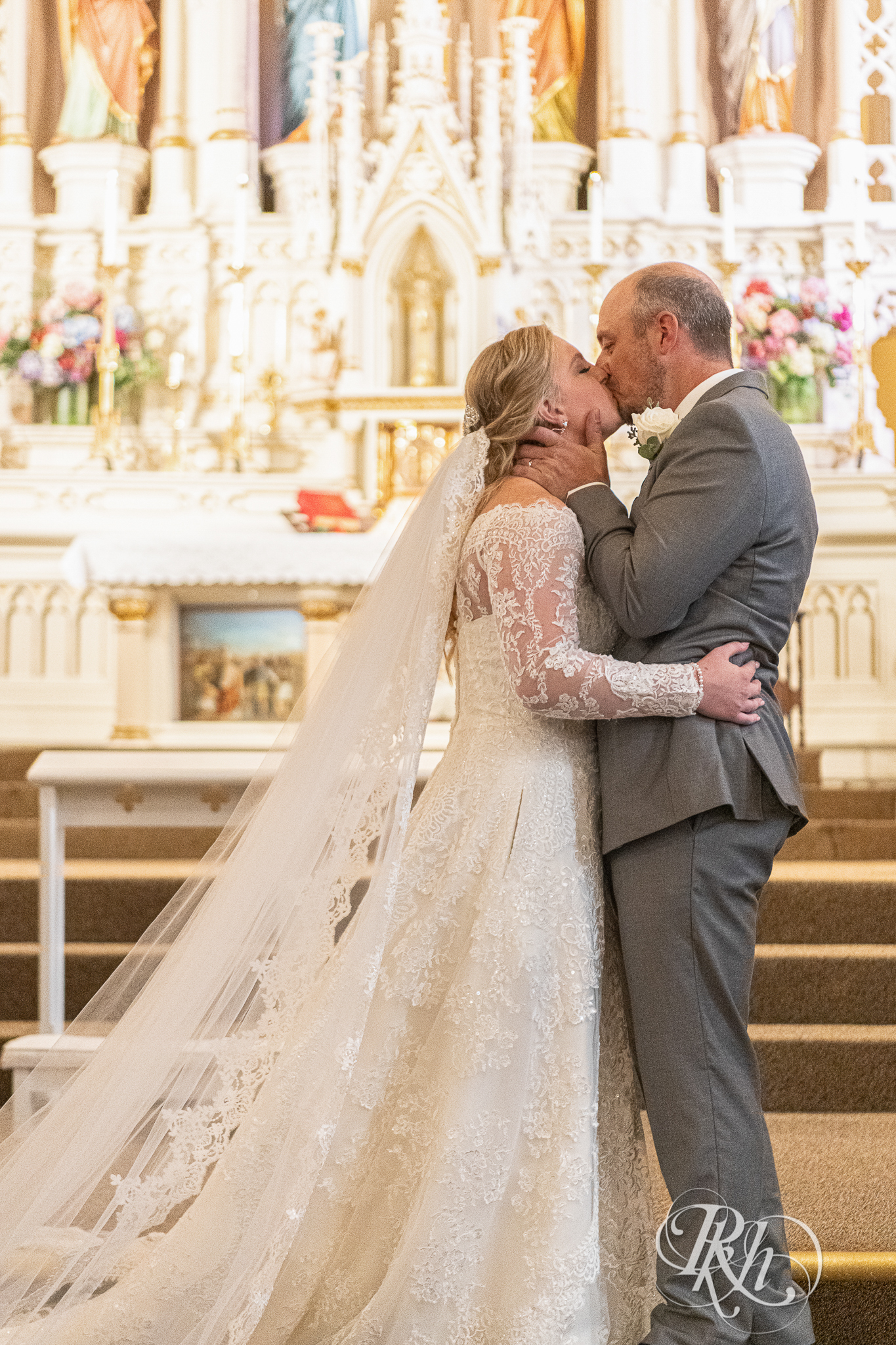 Bride and groom kiss at church wedding in New Prague, Minnesota.