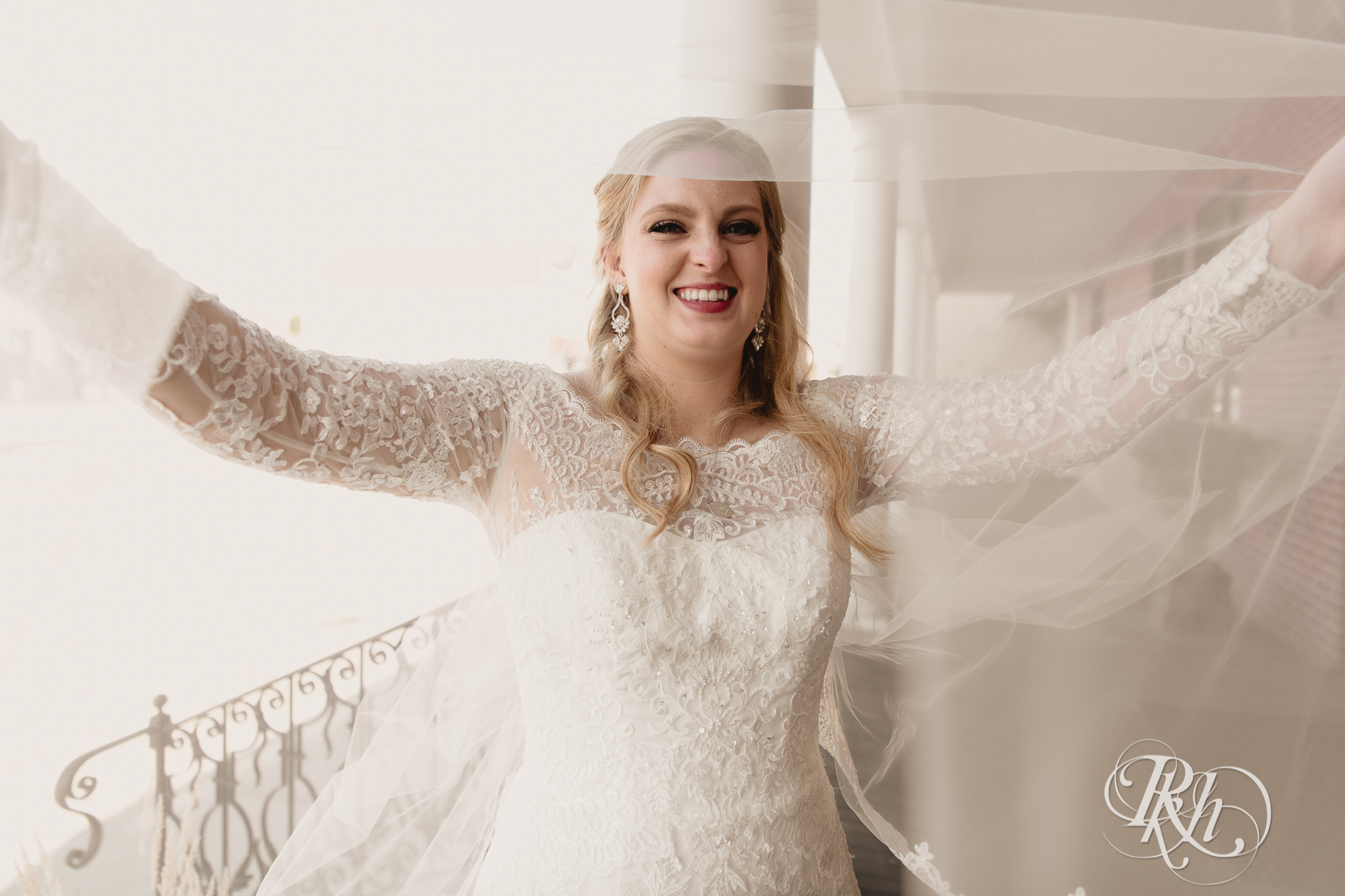 Bride smiles under veil at Weddings at the Broz in New Prague, Minnesota.