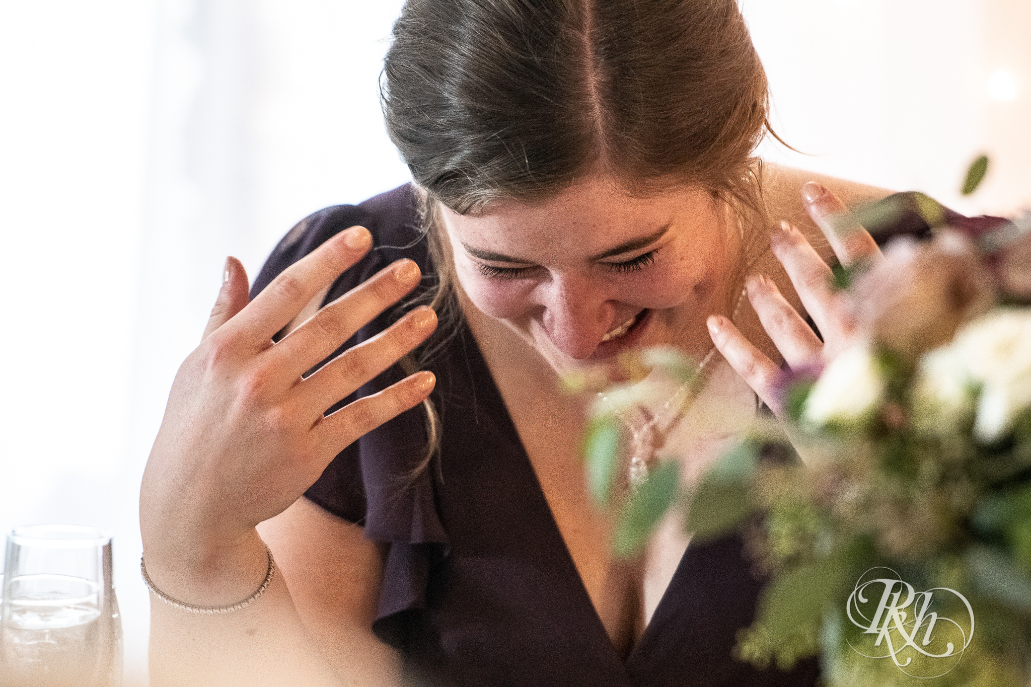 Bridesmaid crying at wedding speech at wedding reception at Weddings at the Broz in New Prague, Minnesota.