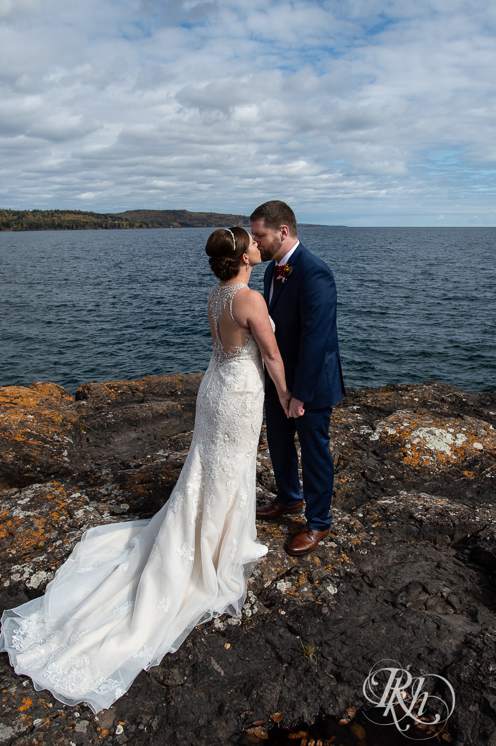 Bride and groom share first look on rock in front of Lake Superior at Superior Shores Resort in Two Harbors, Minnesota.