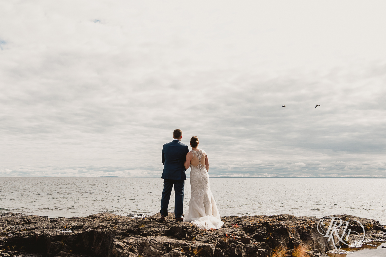 Bride and groom look at Lake Superior at Superior Shores Resort in Two Harbors, Minnesota.