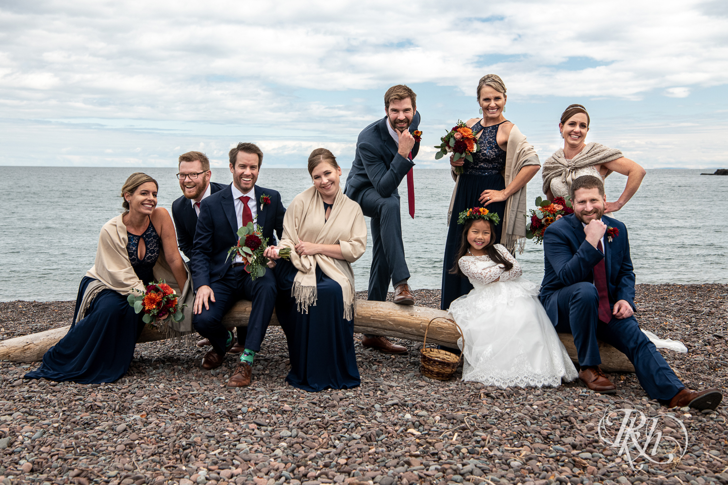 Wedding party laughing in front of Lake Superior at Superior Shores Resort in Two Harbors, Minnesota.