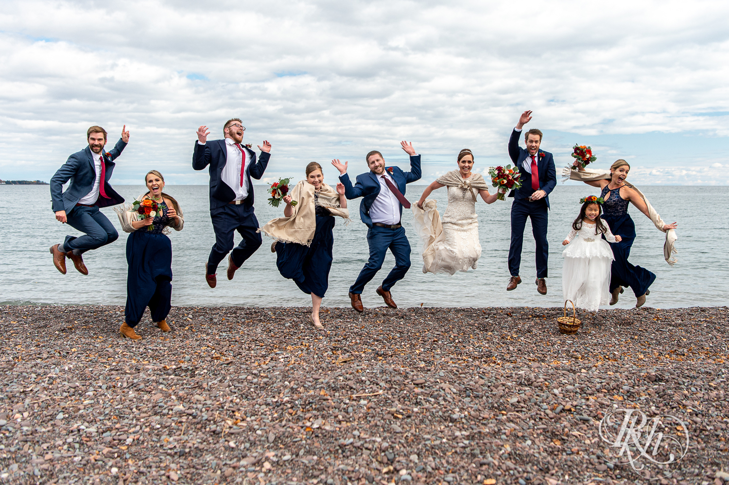 Wedding party jump in front of Lake Superior at Superior Shores Resort in Two Harbors, Minnesota.