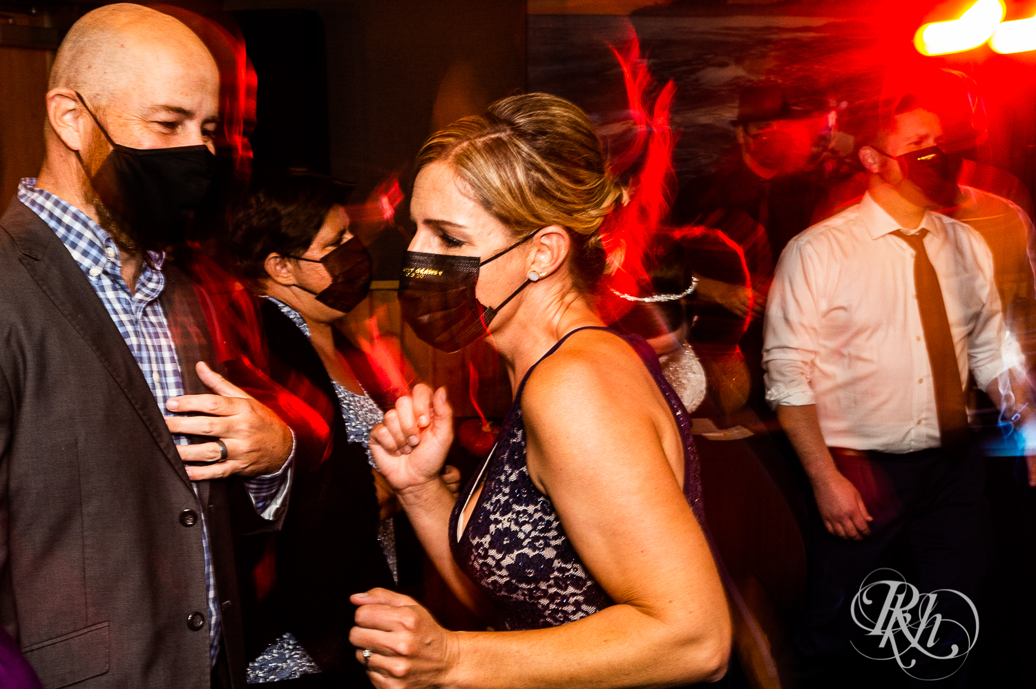 Guests dance with bride and groom at reception at Superior Shores Resort in Two Harbors, Minnesota.