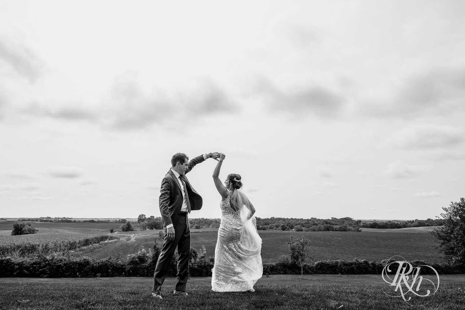 Bride and groom dance on hill at Legacy Hills Farm in Welch, Minnesota.